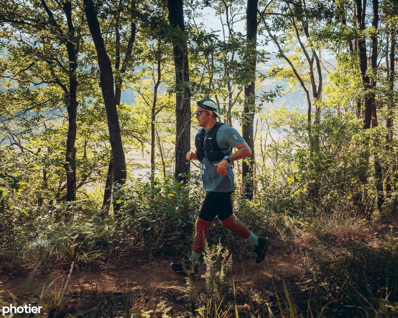 Zavosh running on a wooded trail